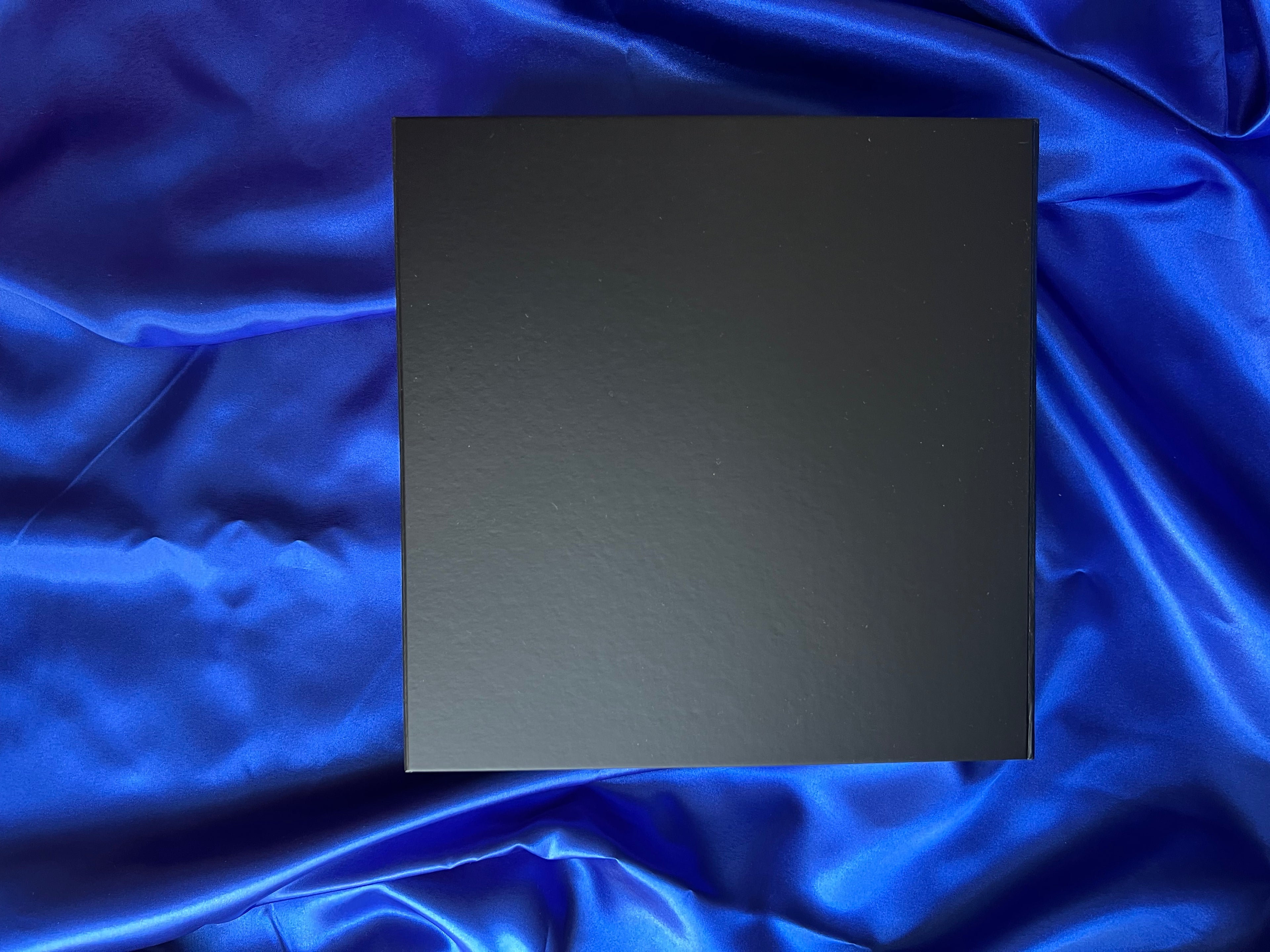 Black corporate gift on a blue satin background