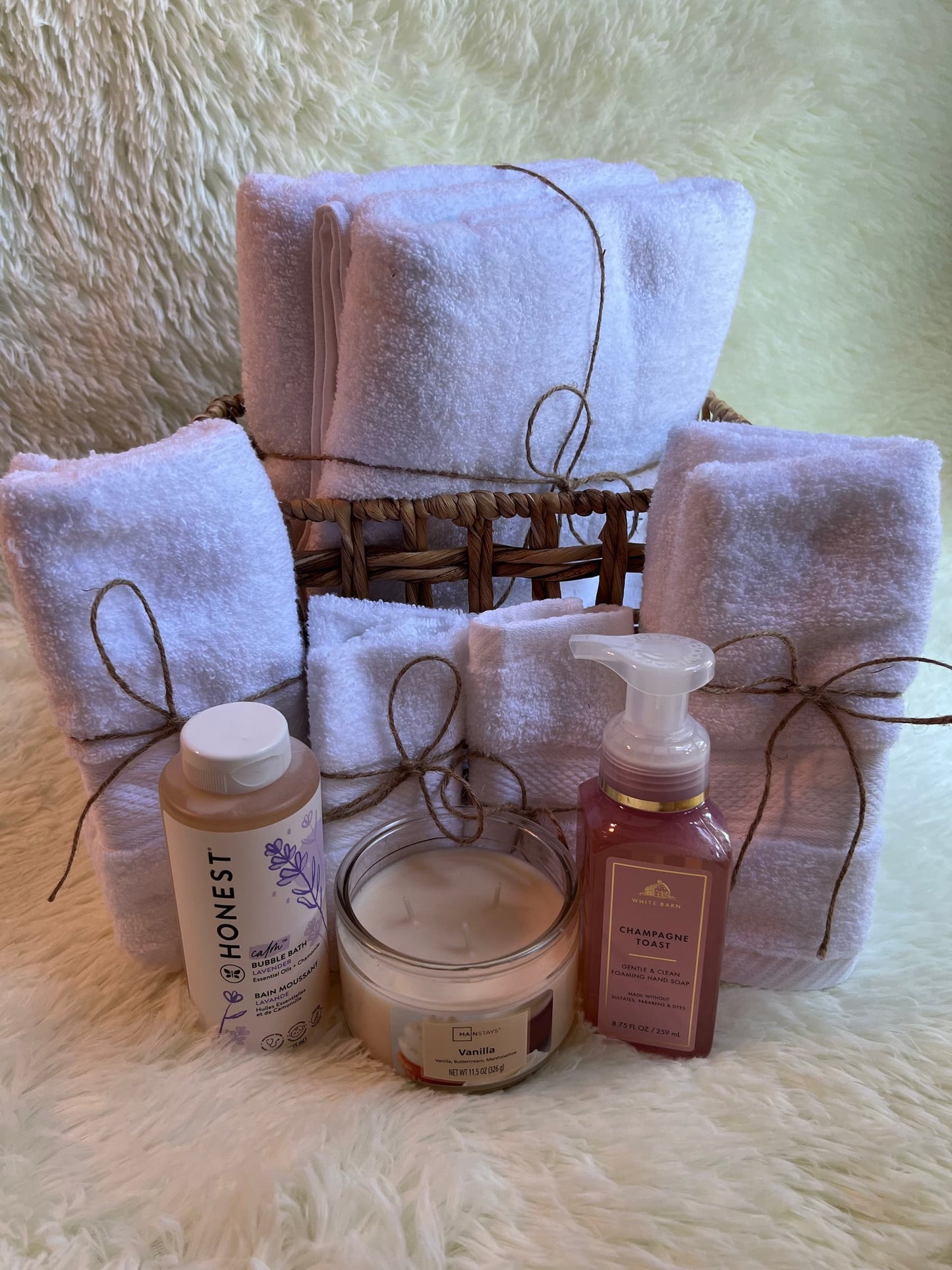 Bath towel set with body care products on a textured surface